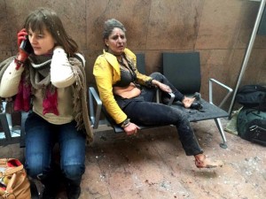 In this photo provided by Georgian Public Broadcaster and photographed by Ketevan Kardava two women wounded in Brussels Airport in Brussels, Belgium, after explosions were heard Tuesday, March 22, 2016. A developing situation left at least one person and possibly more dead in explosions that ripped through the departure hall at Brussels airport Tuesday, police said. All flights were canceled, arriving planes were being diverted and Belgium's terror alert level was raised to maximum, officials said. (Ketevan Kardava/ Georgian Public Broadcaster via AP)